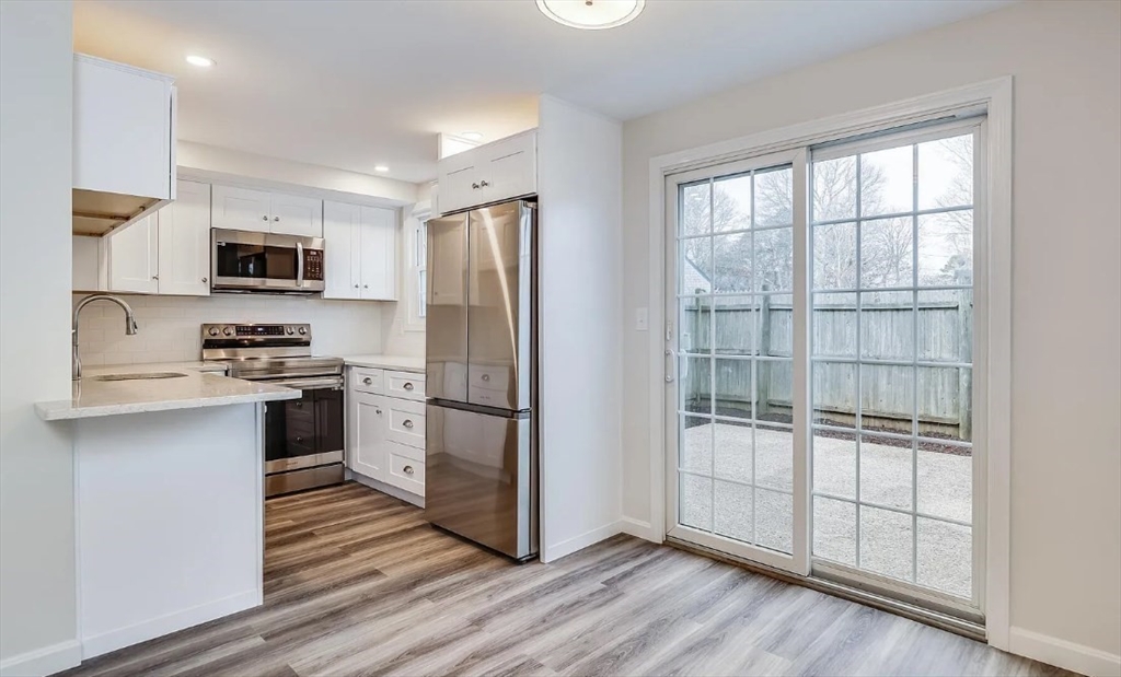 135 West Main Street, Unit 11 Barnstable, MA 02601 - Photo 5 of 11 a kitchen with a refrigerator and a stove top oven