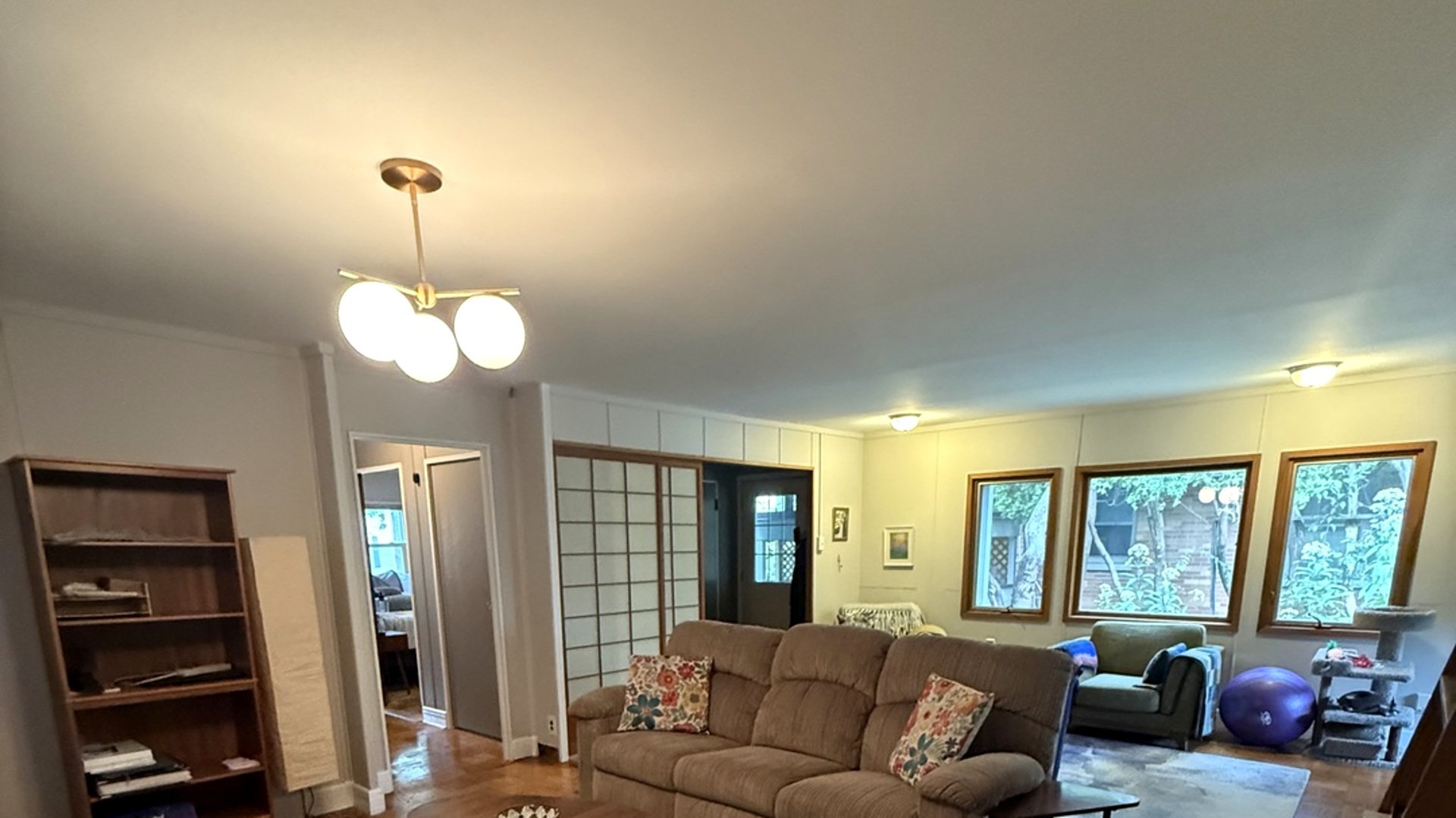 707 West Iowa Street Urbana, IL 61801 - Photo 3 of 25 a living room with furniture chandelier and large windows