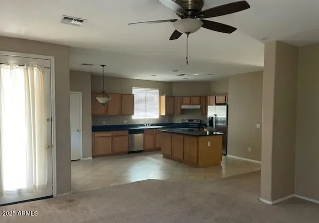 a kitchen with stainless steel appliances granite countertop a sink and cabinets