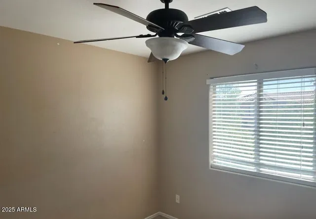 a view of a chandelier fan and a window