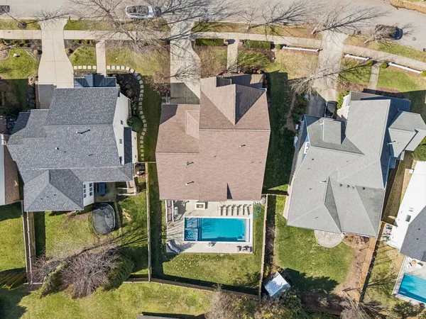 an aerial view of a house with a yard