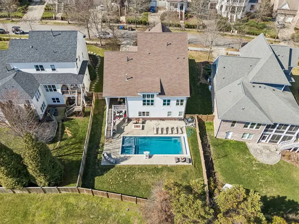 an aerial view of a house with garden space and street view