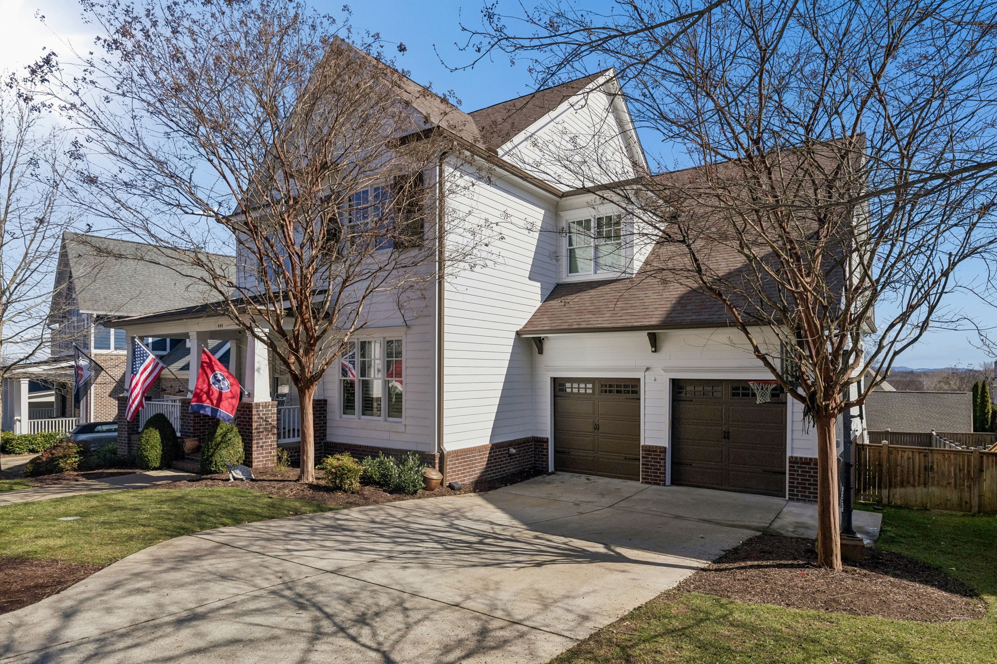 444 Wild Elm Street Franklin, TN 37064 - Photo 4 of 30 a view of a white house with a small yard and a large tree