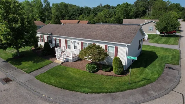 a aerial view of a house with a yard and potted plants