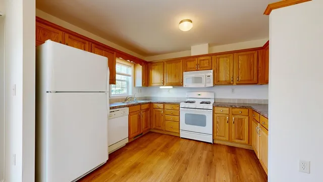 a kitchen with stainless steel appliances granite countertop a refrigerator and a stove top oven