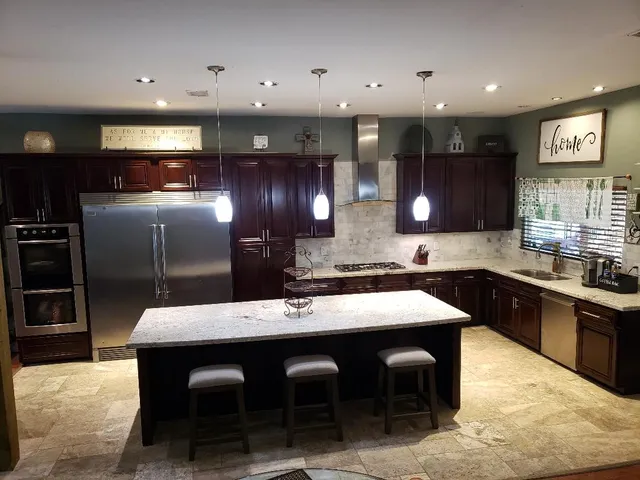 a large kitchen with a table and chairs