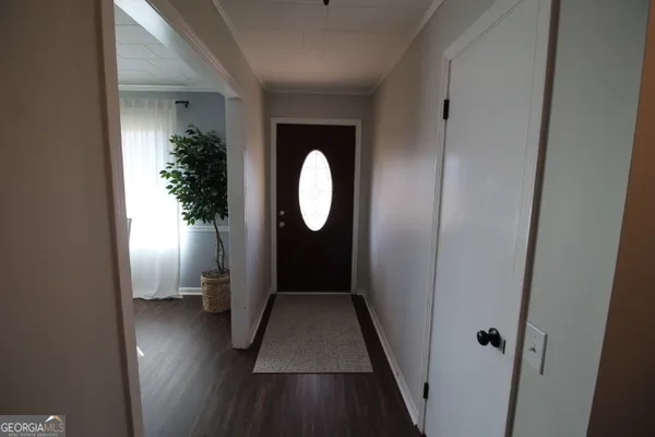 a view of a hallway with wooden floor