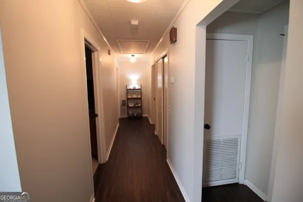 a view of a hallway with a wooden door