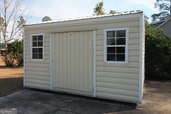 a view of a house with a window and a yard
