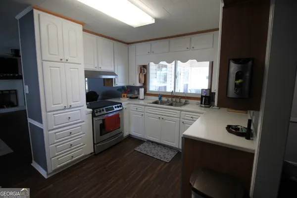 a kitchen with a stove a sink and a refrigerator