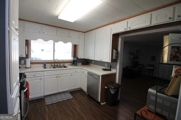 a kitchen with a sink window and cabinets