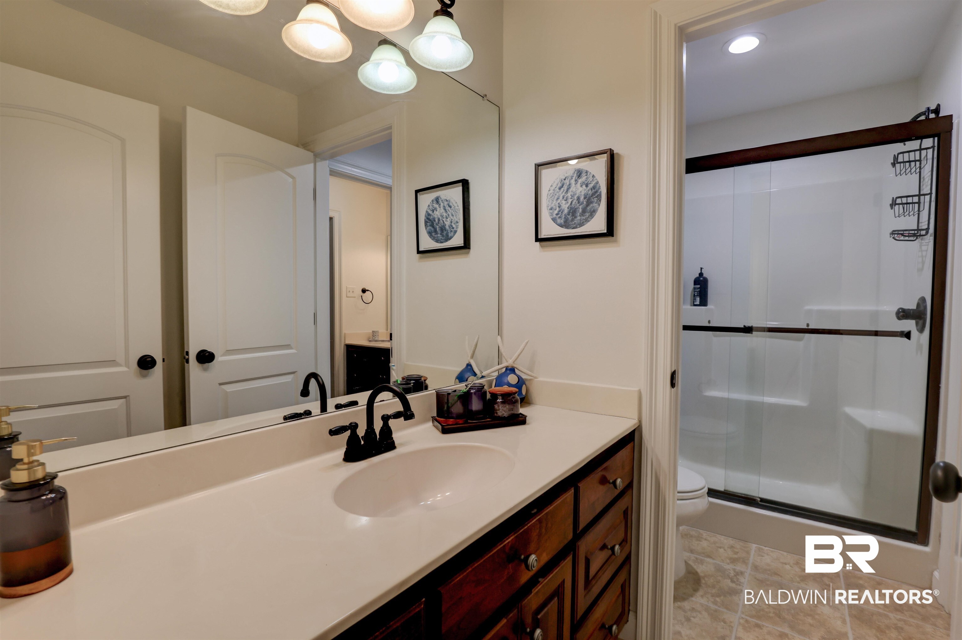 5565 Dawes Lane Theodore, AL 36582 - Photo 20 of 38 Bathroom featuring tile patterned floors, a shower with shower door, toilet, and vanity