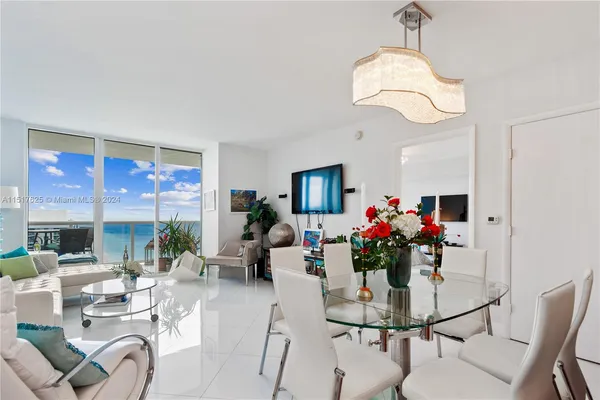 a dining room with furniture a livingroom and chandelier