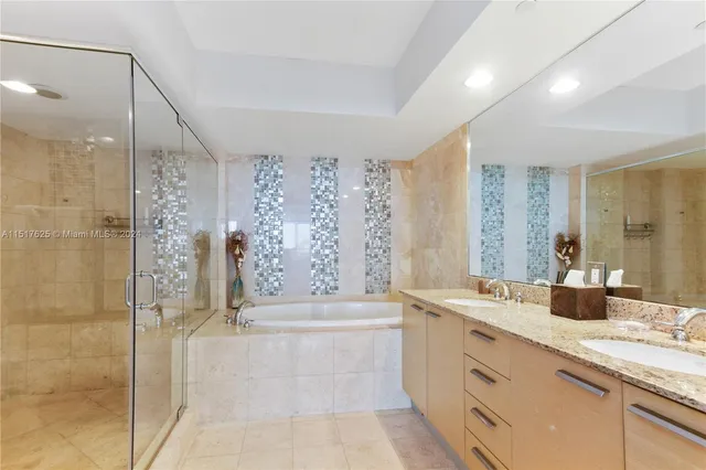 a spacious bathroom with a double vanity sink mirror and shower
