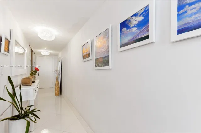a view of a hallway with paintings on the wall