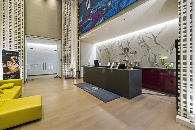 a room with gym equipment and large glass windows