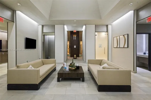a living room with patio furniture and a flat screen tv