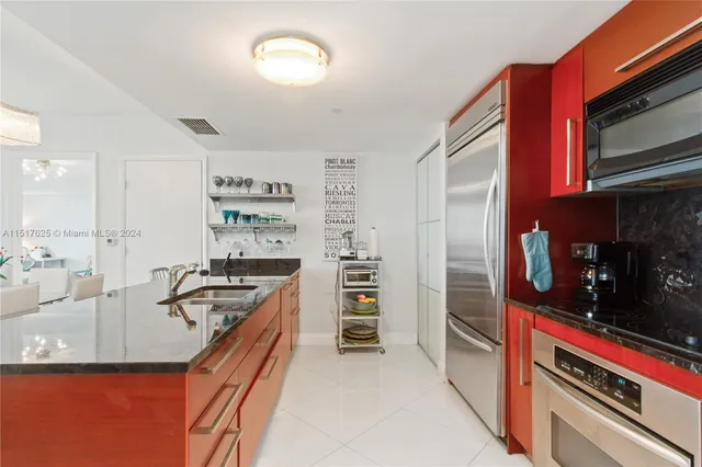 a kitchen with stainless steel appliances granite countertop a sink and a stove