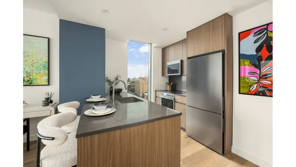 a kitchen with a refrigerator and a stove top oven