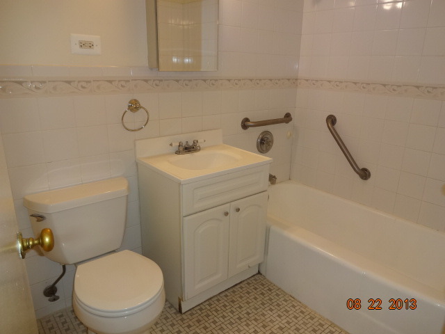 6030 North Sheridan Road, Unit 912 Chicago, IL 60660 - Photo 5 of 7 a bathroom with a sink a toilet and bathtub
