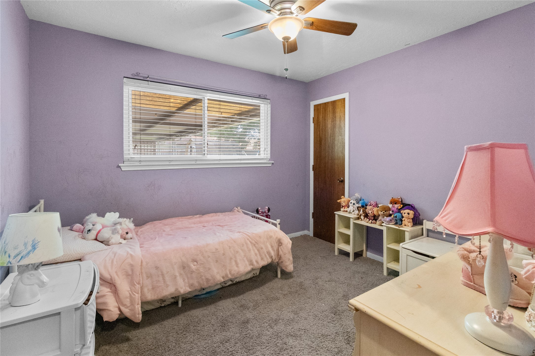 4322 Aztec Street Pasadena, TX 77504 - Photo 12 of 18 a bedroom with a bed and a chandelier