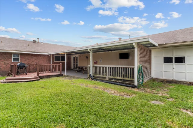 a view of a house with a backyard and a patio