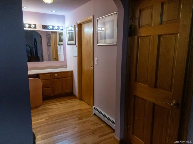 a view of a hallway with wooden floor