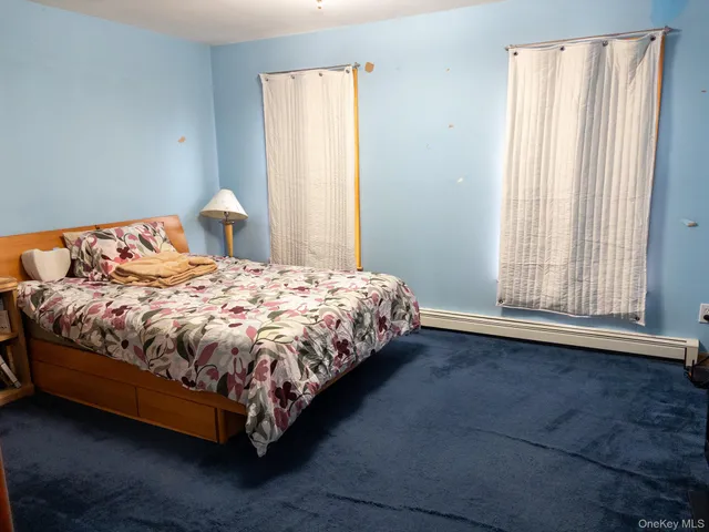 a large bed sitting in a bedroom next to a window