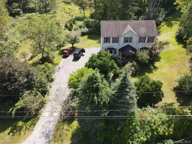 an aerial view of a house with a yard