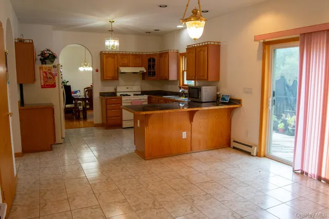 a kitchen with stainless steel appliances granite countertop a refrigerator and a stove