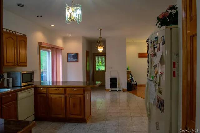 a view of a hallway with kitchen and entryway