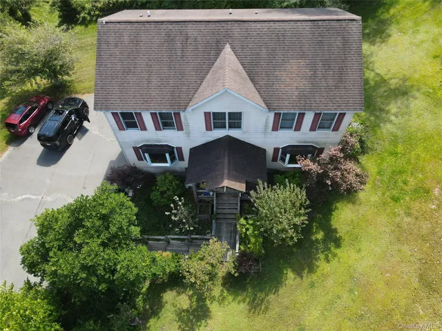 an aerial view of a house with swimming pool and garden