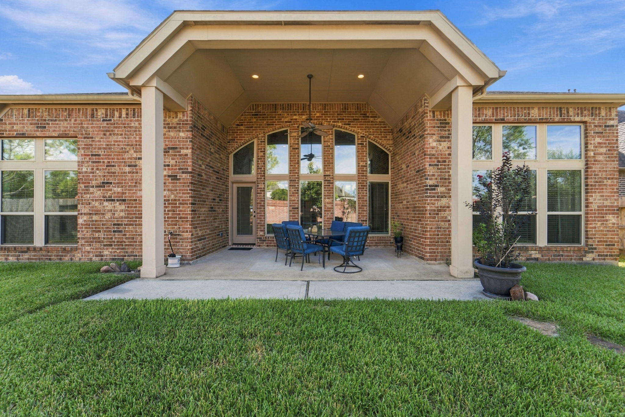 9818 Reston Ranch Court Cypress, TX 77433 - Photo 32 of 38 Step outside to your own private backyard retreat, complete with a covered patio featuring a ceiling fan and soaring brick columns. This is the perfect spot for morning coffee or evening gatherings, rain or shine.