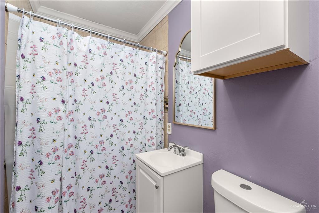 118 J R Becerra Avenue Progreso, TX 78596 - Photo 7 of 17 a bathroom with a sink toilet and vanity