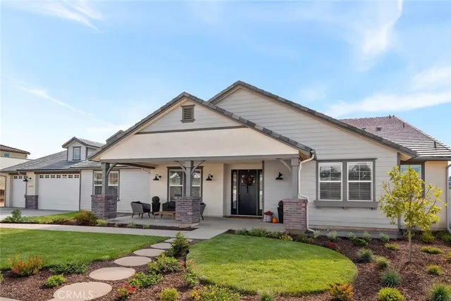 a front view of a house with a yard outdoor seating and garage