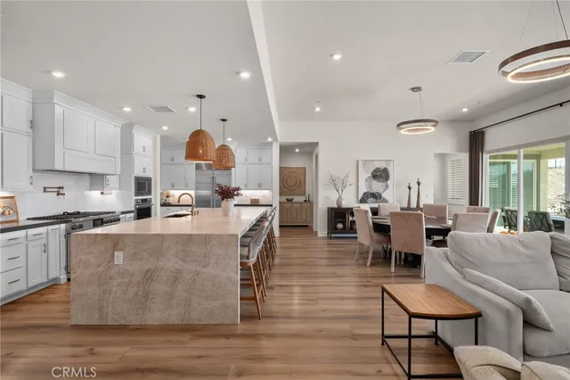 a view of kitchen with stainless steel appliances granite countertop sink stove and cabinets