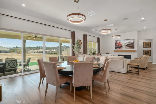 a dining room with furniture window and wooden floor
