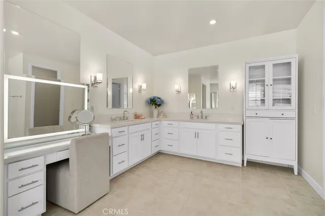 a spacious bathroom with a granite countertop sink mirror and