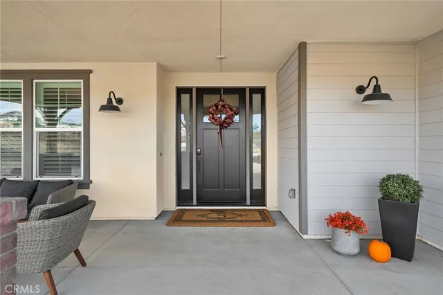 a living room with furniture and flowers