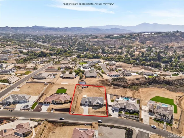 a view of house with outdoor space and a garden