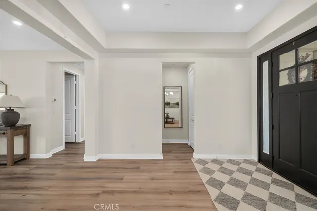 a view of an empty room and wooden floor