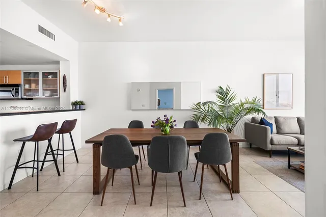 a view of a dining room with furniture and a potted plant