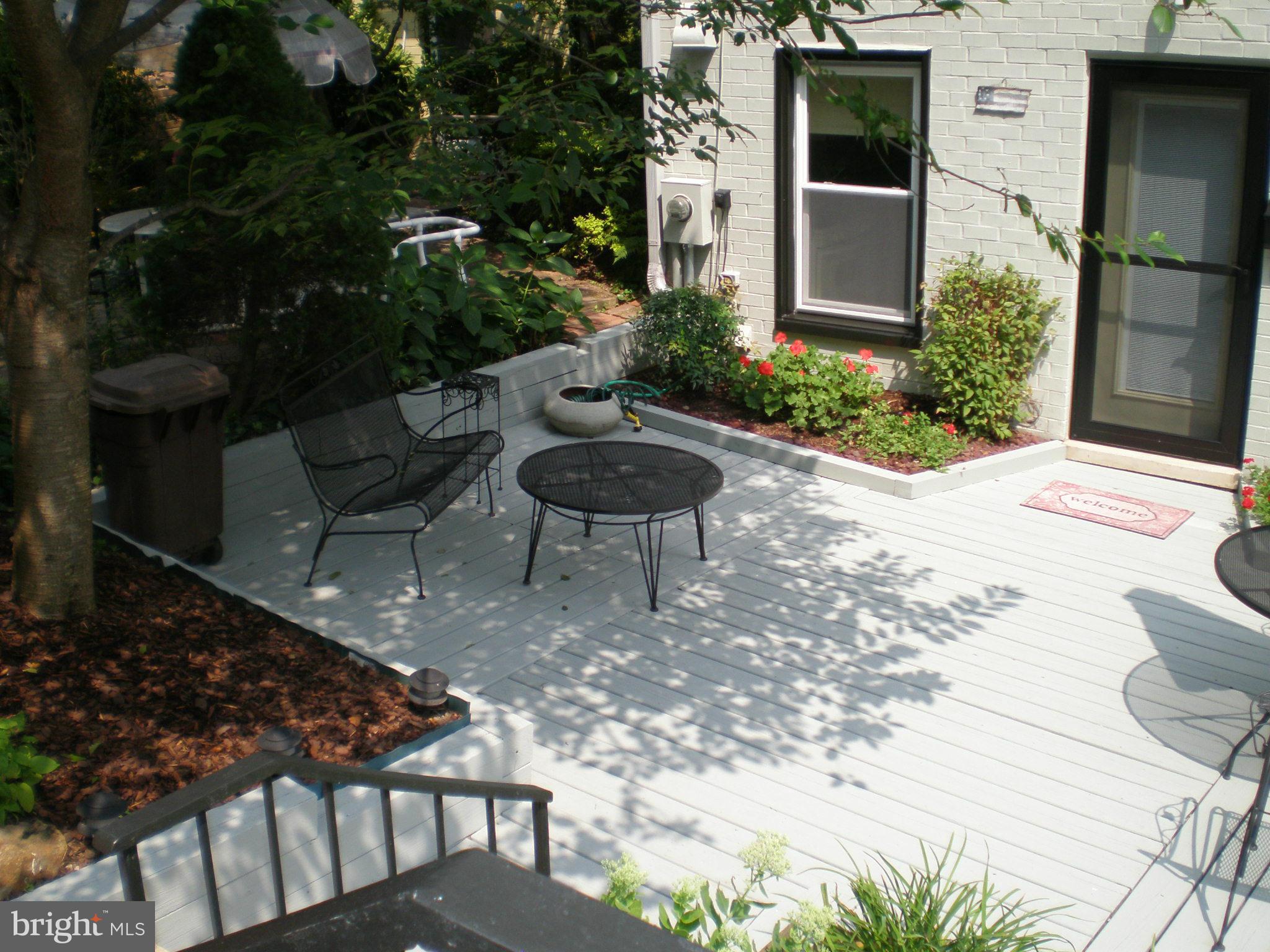 11446 Waterview Cluster Reston, VA 20190 - Photo 2 of 30 a backyard of a house with table and chairs potted plants