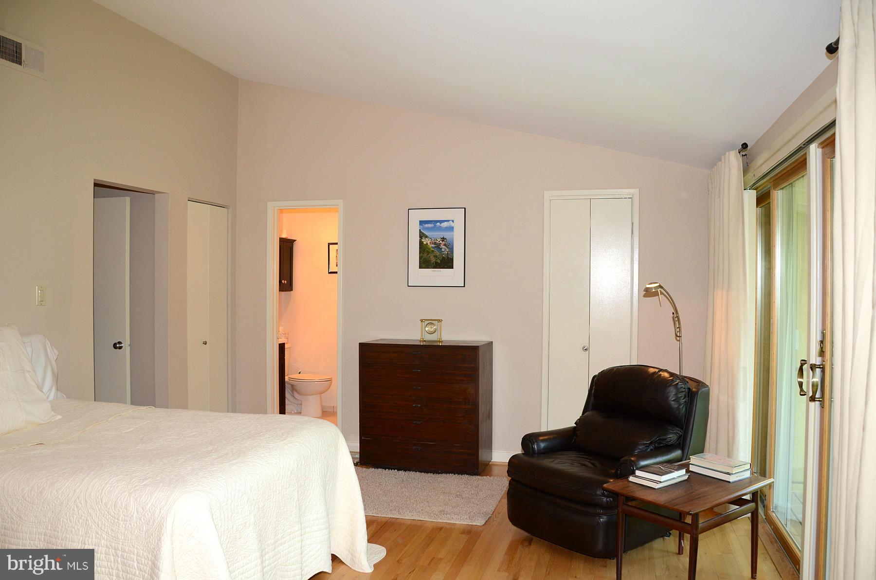 11446 Waterview Cluster Reston, VA 20190 - Photo 12 of 30 a bedroom with a bed and wooden floor