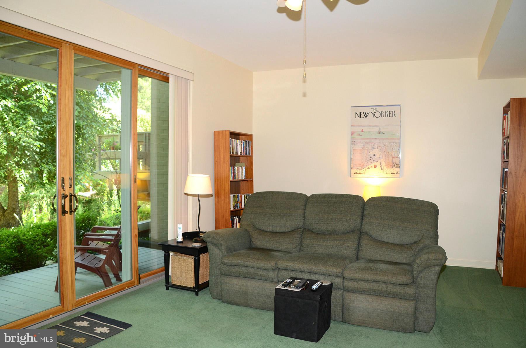 11446 Waterview Cluster Reston, VA 20190 - Photo 14 of 30 a living room with furniture a flat screen tv and a floor to ceiling window