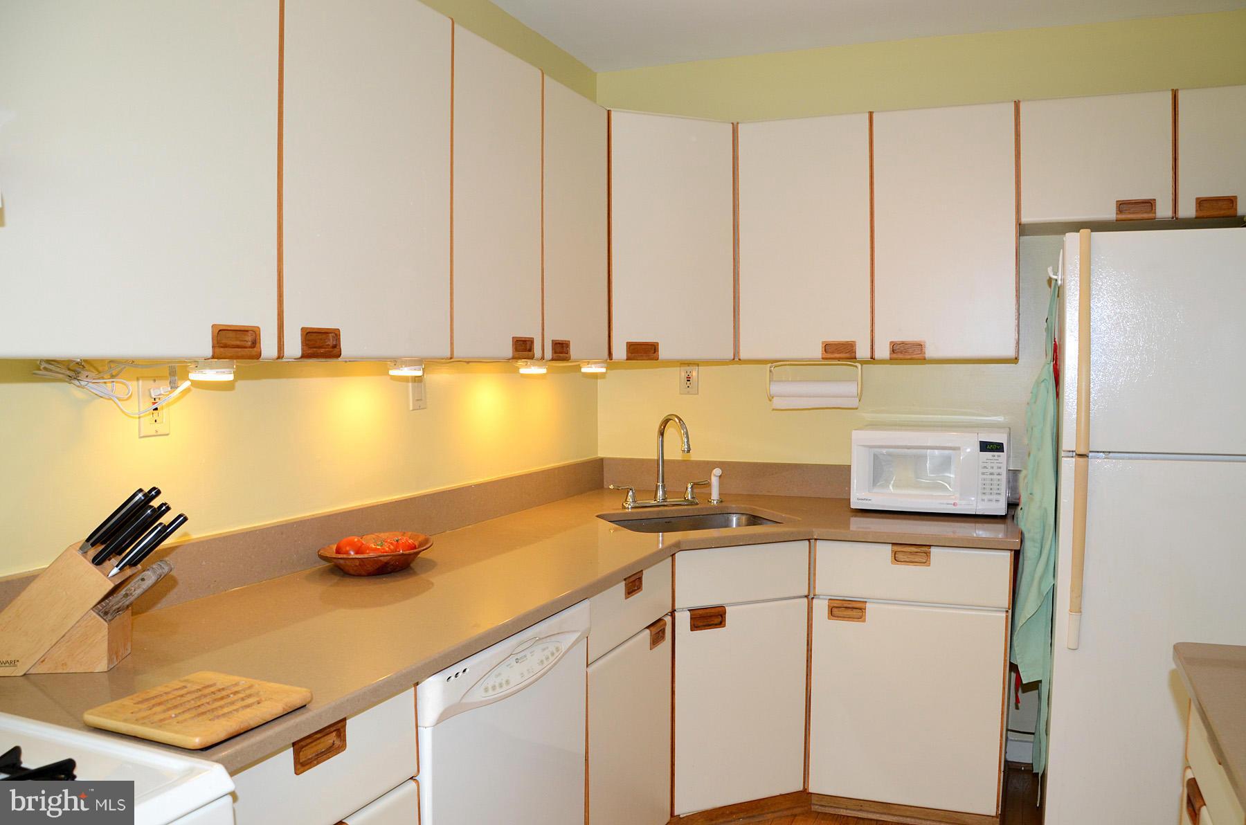 11446 Waterview Cluster Reston, VA 20190 - Photo 4 of 30 a kitchen with stainless steel appliances granite countertop a sink a stove and a refrigerator