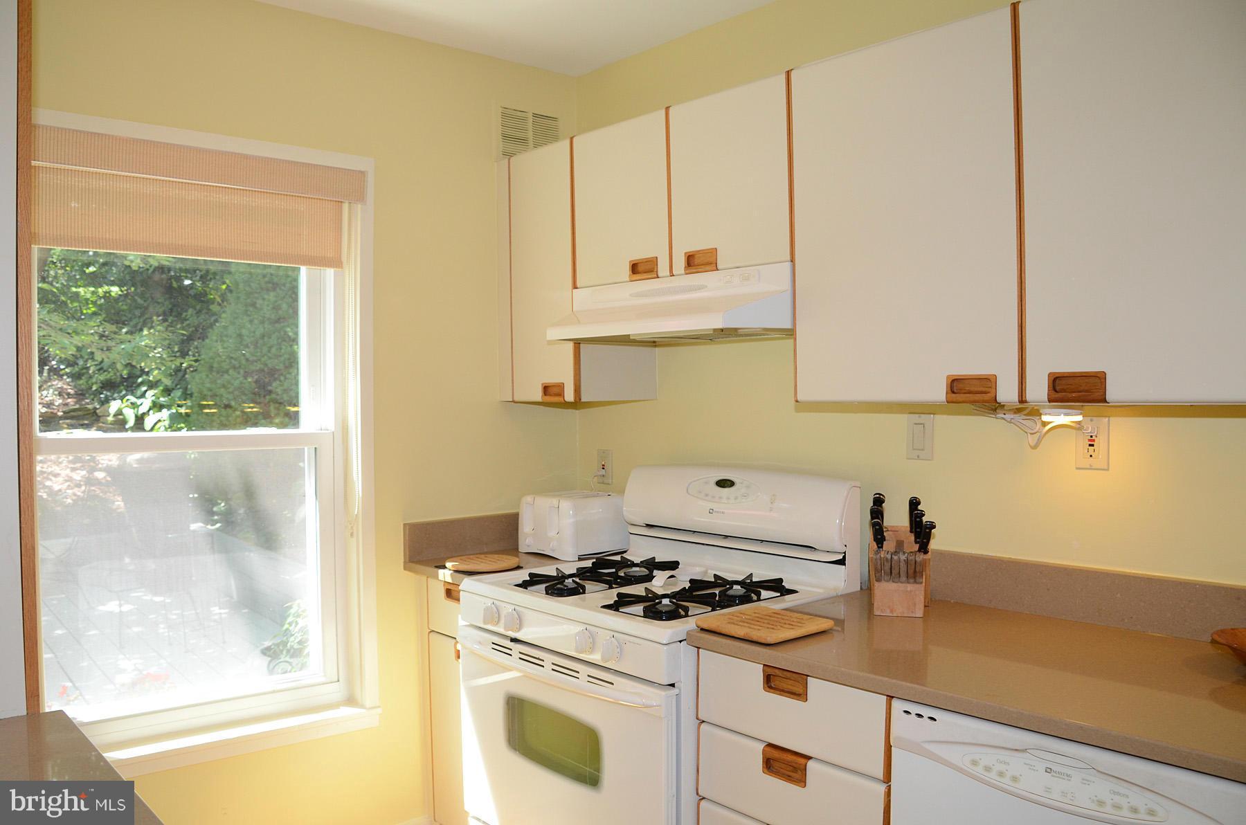 11446 Waterview Cluster Reston, VA 20190 - Photo 5 of 30 a kitchen with a stove a sink and a granite counter top