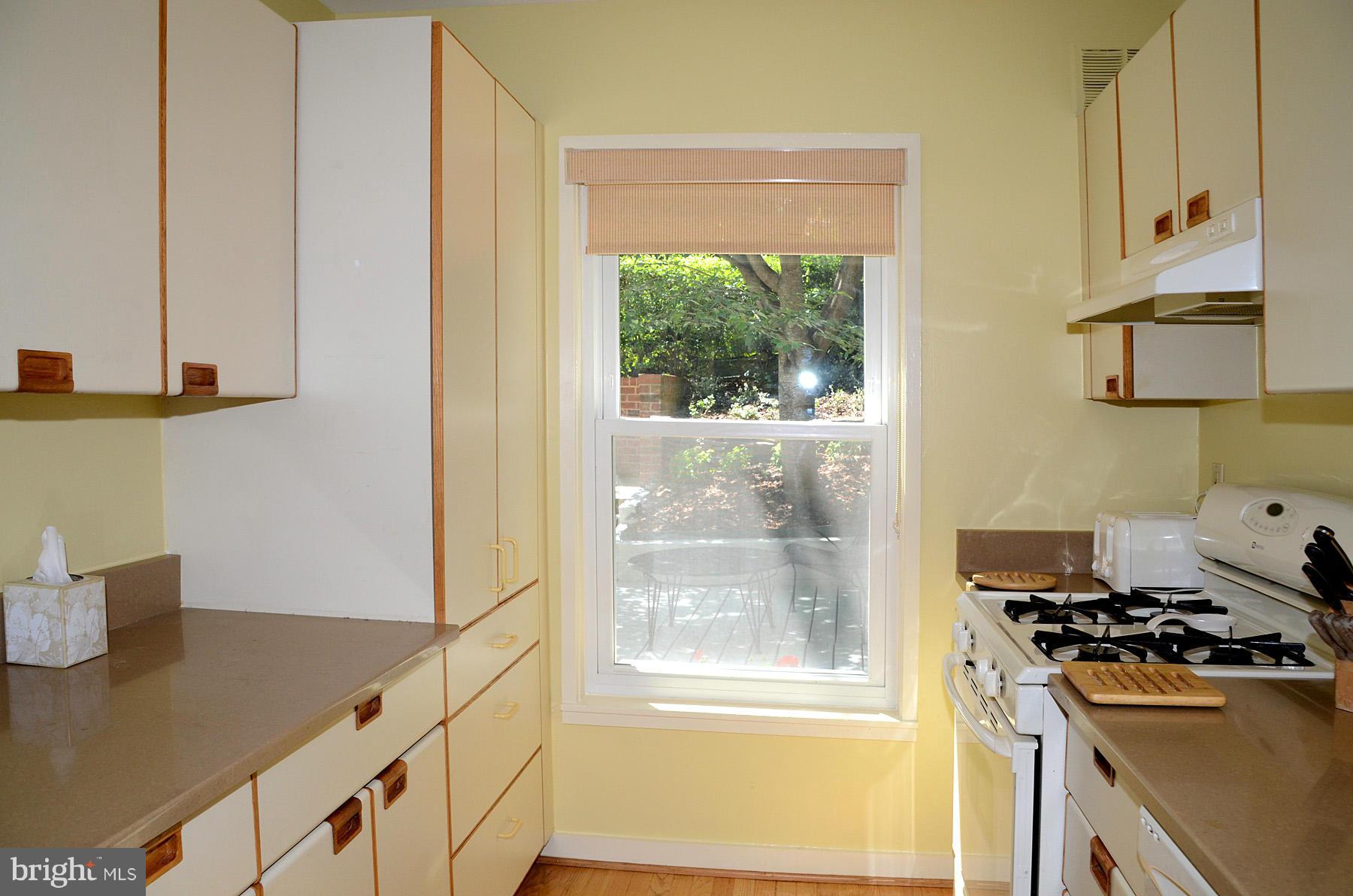 11446 Waterview Cluster Reston, VA 20190 - Photo 6 of 30 a kitchen with a stove a refrigerator and a window