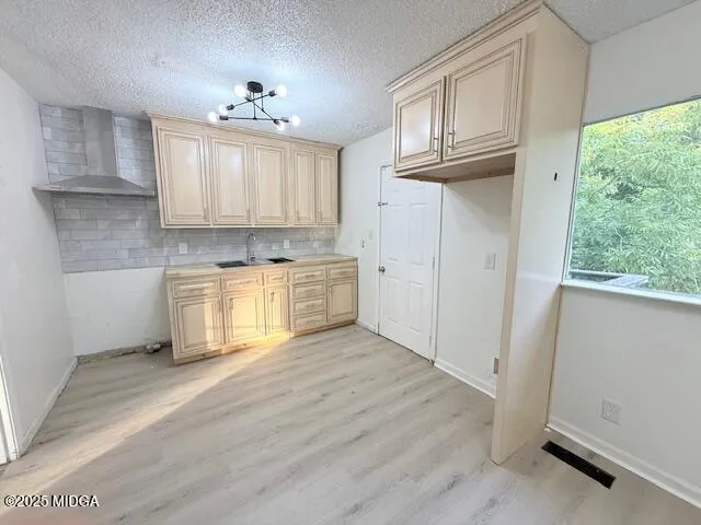 a view of a kitchen with wooden cabinet and a window