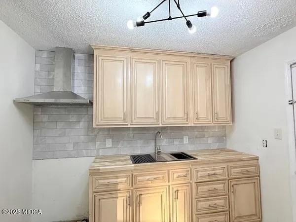 a kitchen with stainless steel appliances granite countertop a sink a stove and white cabinets